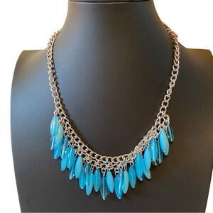 Turquoise Colored Beaded Necklace on Silver Toned Chain. Earrings included.